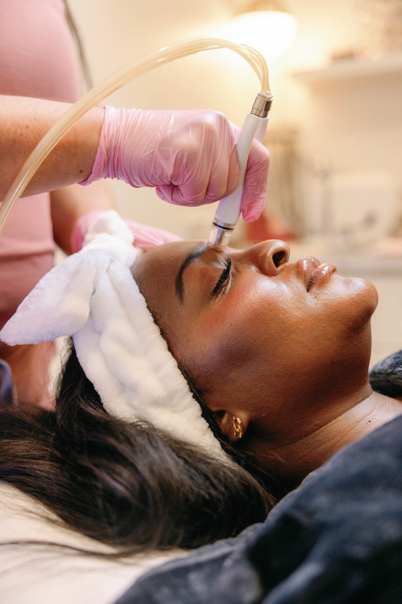 Patient receiving DiamondGlow Facial for glowing, healthy skin at Meg Fox Aesthetics